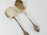 two spoons that are sitting next to each other on a table