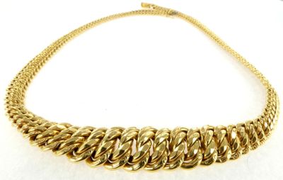 a close up of a gold chain necklace on a white background
