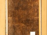 a painting of a brown frame with a white label on it