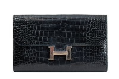 a black leather wallet with a metal clasp on the front