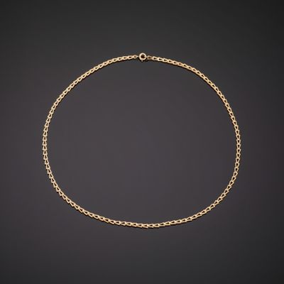 a gold chain necklace on a black background