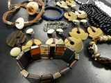 many different pieces of jewelry on a black table