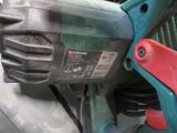a close up of a corded drill on a table