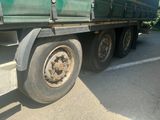 a green truck that is parked on the side of the road