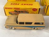 three toy cars are sitting on a table next to boxes of other toys