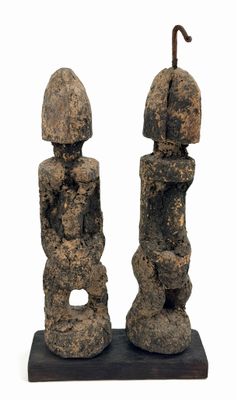 pair of stone statues with umbrellas on a stand on a white background