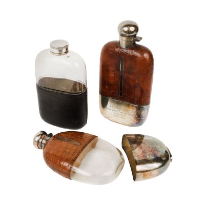 three bottles of perfume sitting next to each other on a white surface