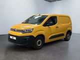 a yellow van parked in a white room with a black floor