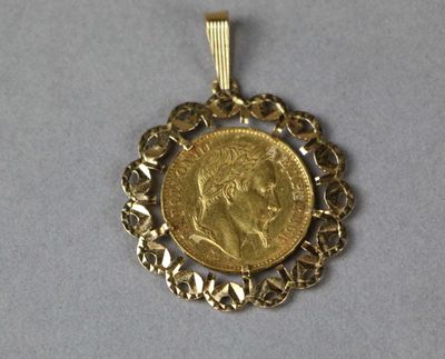 a close up of a gold coin with a chain around it