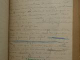 an open book with a handwritten page on it sitting on a table