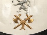 a white helmet with gold stars and a lion on it