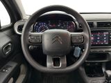 the interior of a car with a steering wheel and dashboard controls