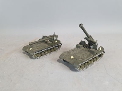 two toy tanks that are sitting on a white surface