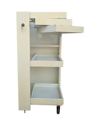 a small white cabinet with a drawer on wheels