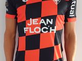 Cet homme porte un t-shirt rouge et noir et un pantalon noir.