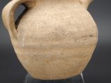 a small vase that is sitting on a clear base
