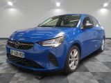 a blue car parked on a checkered floor in a garage