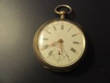 clock with roman numerals on the face on a black surface