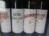 three bottles of wine are on display in a store window