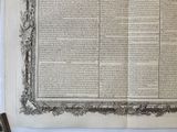 an old book is open on a table next to a pen and paper