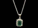 an emerald and diamond pendant on a silver chain