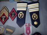several different military badges are laid out on a table