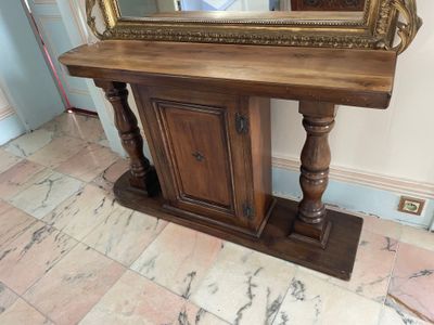 a wooden table with a mirror on top of it