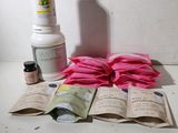 a bottle of lotion, a bottle of lotion and a bag of lotion sitting on a table