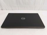 the dell laptop is on a white surface with a white background