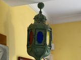 a green lantern hanging from the ceiling in a room