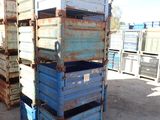 many crates stacked on top of each other in the dirt