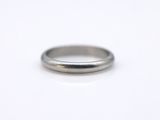a close up of a silver ring on a white surface
