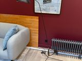a couch and a chair in a room with a radiator