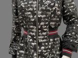 a black and white jacket with a red stripe on the collar