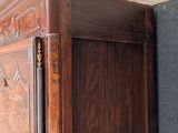 a large wooden bed with a wooden headboard on top of it