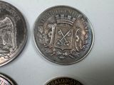 four different types of coins are shown on a white surface