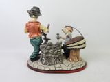 a figurine of a man and a woman sitting on a bench