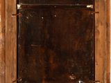 an old window with a wooden frame on the wall