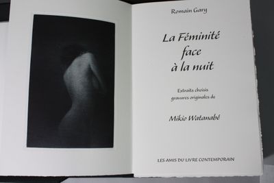 a book with a black and white photo of a woman ' s back