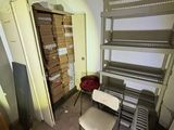 a room with shelves and a chair in it