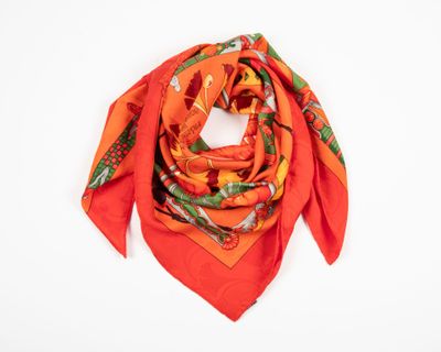 an orange scarf with a floral design on it