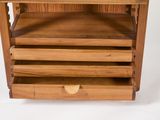 a wooden shelf with three drawers on top of it