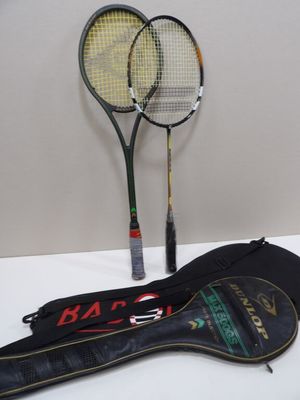 two tennis rackets sitting on a table next to each other