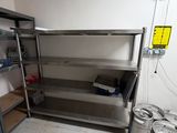 stainless steel shelvings in a kitchen with beer kegs on the floor