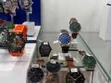 a lot of watches on display in a glass case