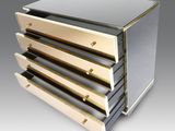 an image of a silver and gold chest of drawers on a grey background