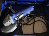 a blue box with a tool in it that is sitting on the floor