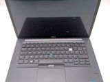a laptop with a keyboard on it sitting on a table