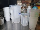 many plastic cups sitting on the counter next to each other