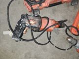 two electric tools that are laying on the ground
